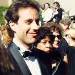 a man in a tuxedo and a woman in a crowd