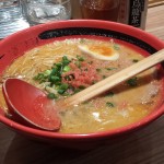 a bowl of ramen soup with a spoon