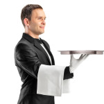 a man in a tuxedo holding a tray