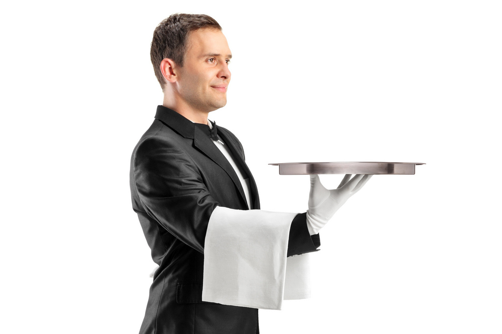 a man in a tuxedo holding a tray