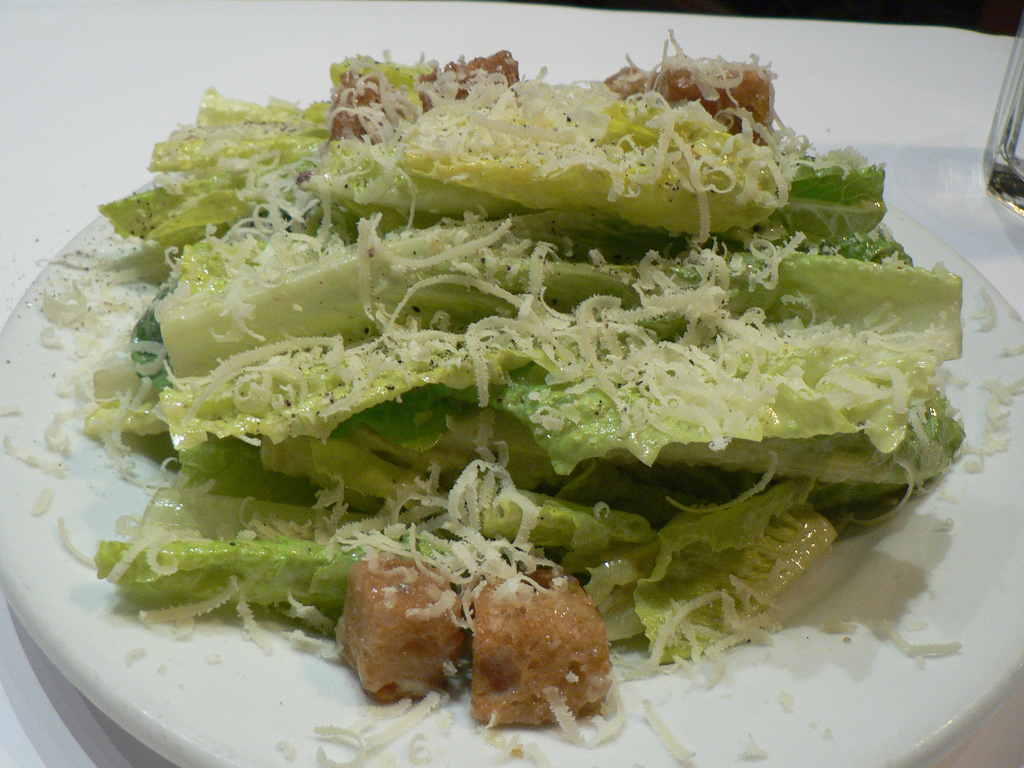 a plate of salad with cheese
