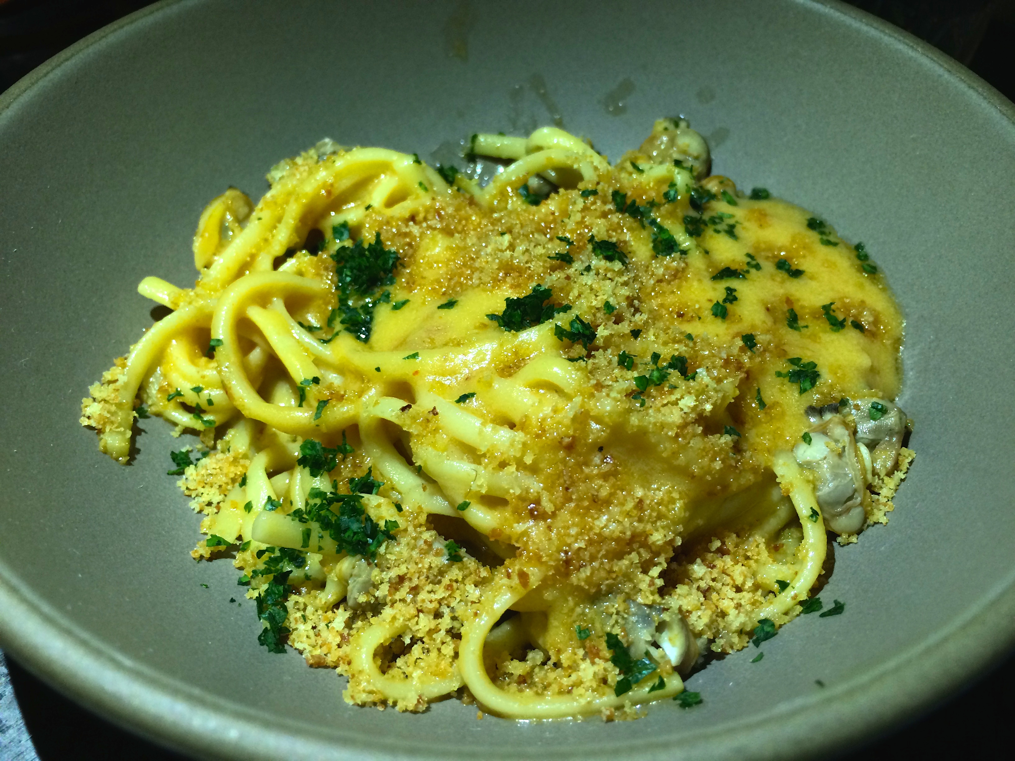 a bowl of pasta with cheese and herbs