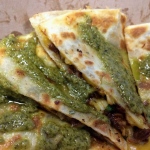 a quesadilla with green sauce