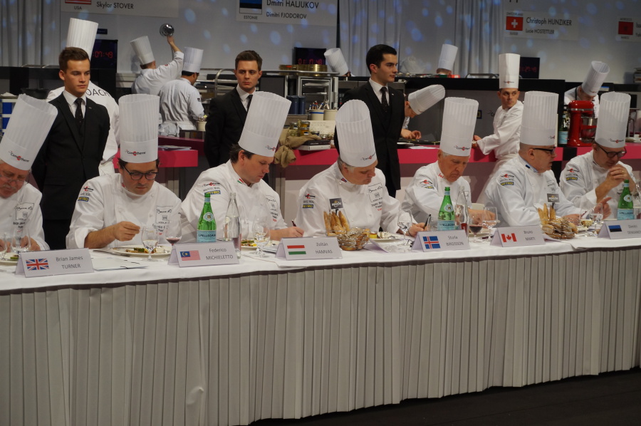 a group of chefs sitting at a table