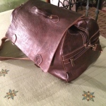 a brown leather bag on a table