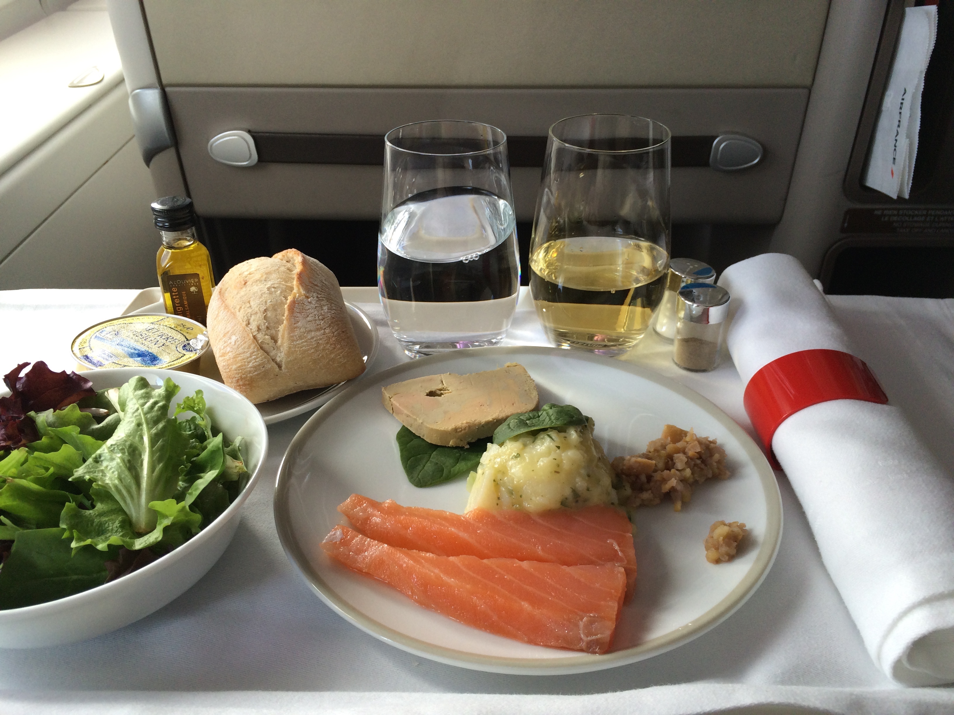 food on a plate with glasses and a napkin on the side