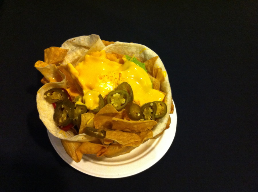 a plate of nachos with cheese and jalapenos