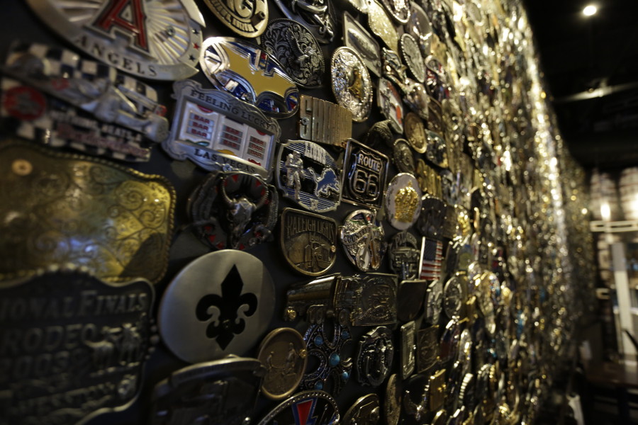 a wall of various metal belts