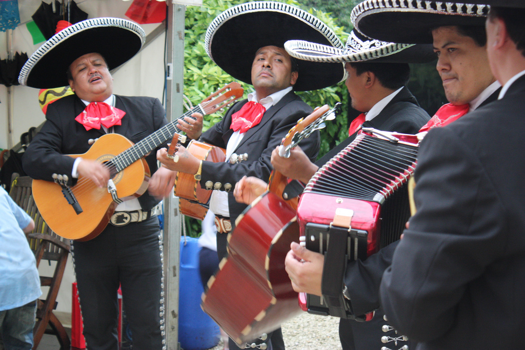 a group of men wearing sombreros playing instruments