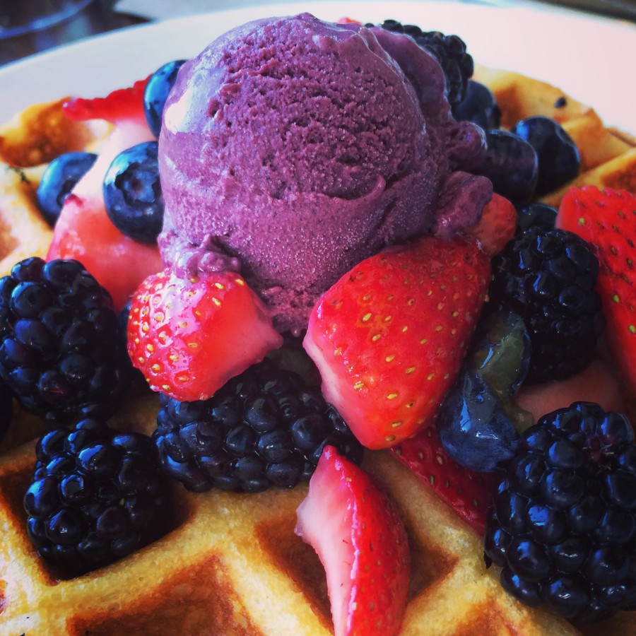 a waffle with fruit and ice cream on top