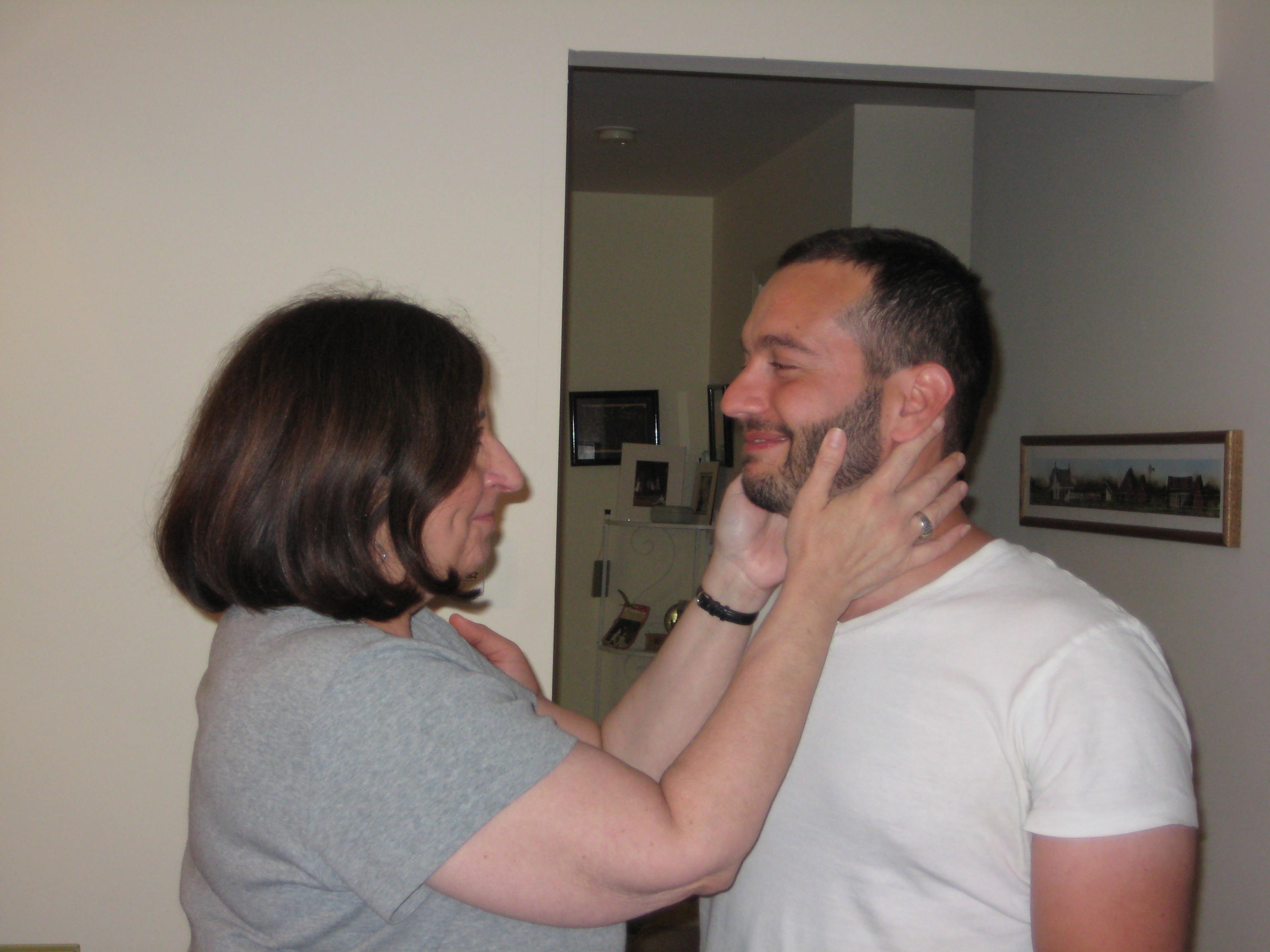 a woman touching a man's neck