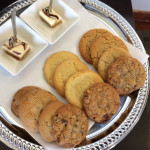 a plate of cookies and a small square plate of desserts