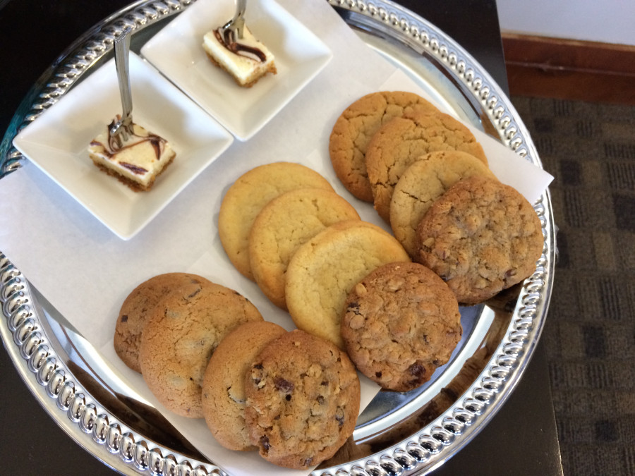 a plate of cookies and a small square plate of desserts