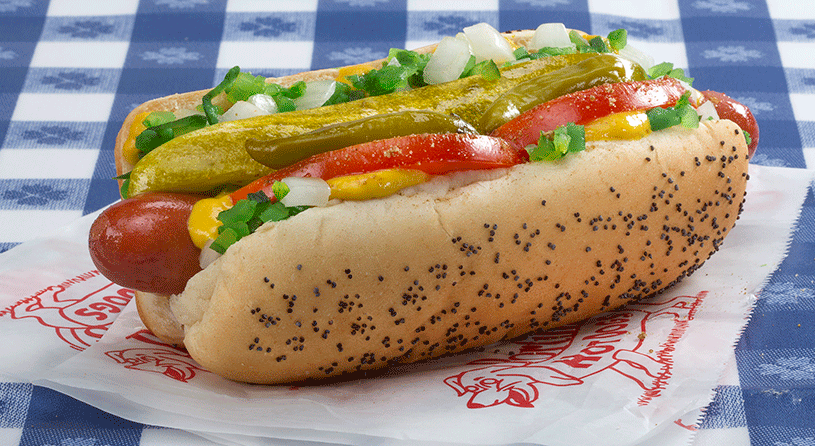 a hot dog with vegetables and cheese on it