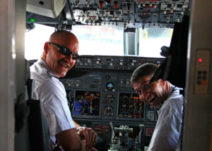 two men in the cockpit of an airplane