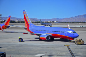 a blue and red airplane on a runway