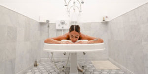 a woman lying on a bathtub