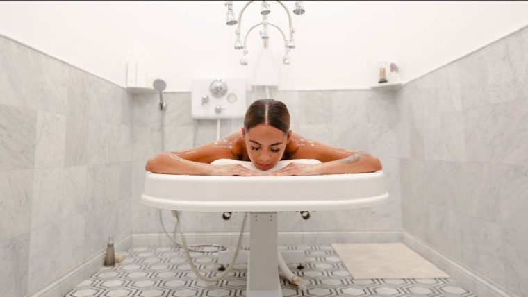 a woman lying on a bathtub