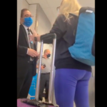 a woman wearing a blue backpack and purple pants with a blue backpack standing next to a man wearing a blue face mask