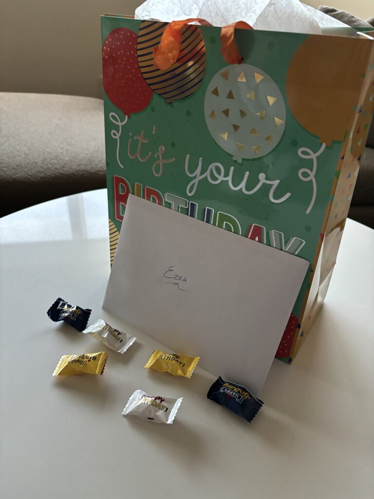 a birthday card and candy in a bag